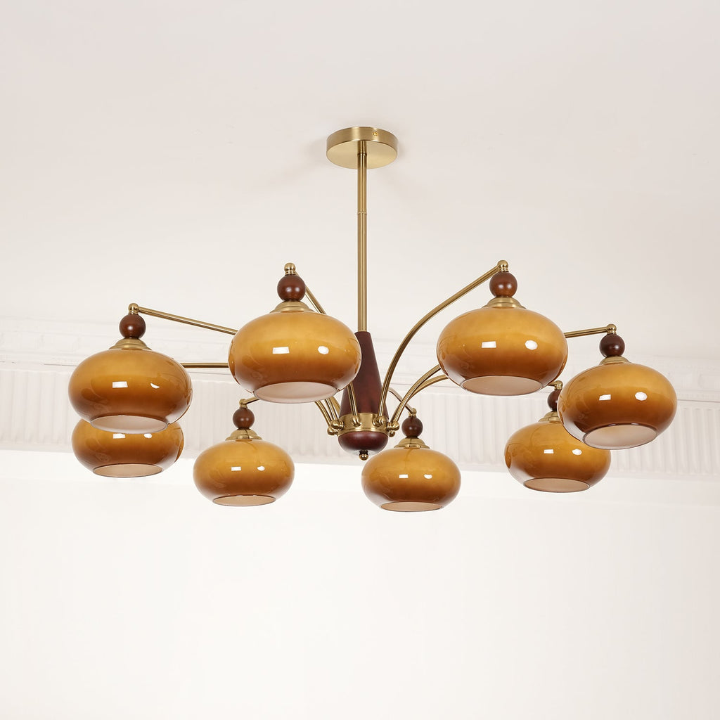 Side view of the unlit Clérachic chandelier, its caramel glass shades looking dark brown on gold arms.