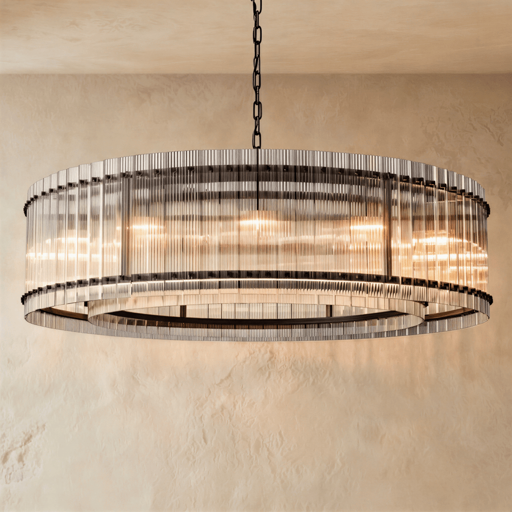 Clérachic widest drum chandelier of fluted glass rods with matte black studs and a tiered inner ring, lit warm on a chain.