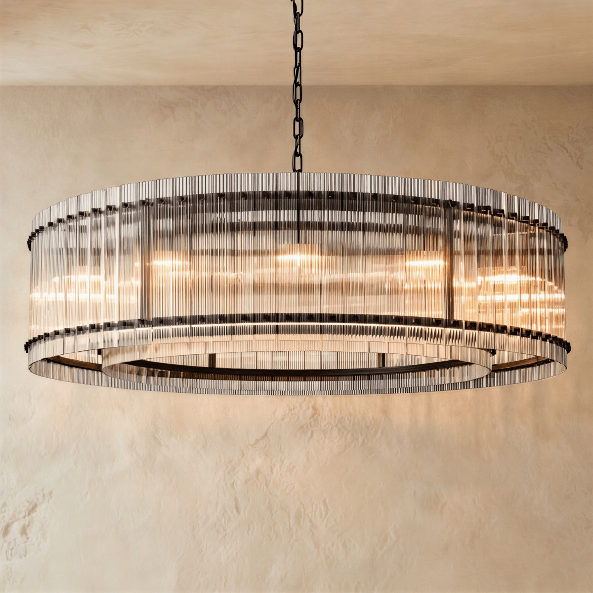 Clérachic widest drum chandelier of fluted glass rods with matte black studs and a tiered inner ring, lit warm on a chain.