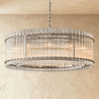 Clérachic larger drum chandelier of fluted glass rods with polished nickel studs and an inner ring, lit warm on a chain.