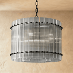 Clérachic compact drum chandelier of clear fluted glass rods with matte black studs, switched off and see-through on a chain.