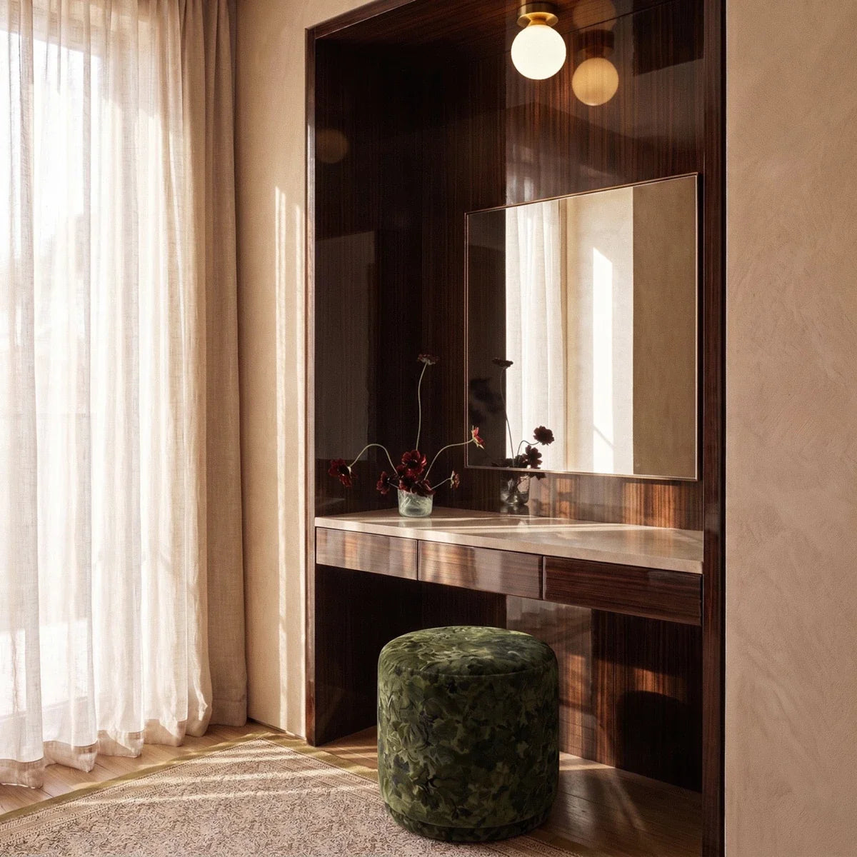 Clérachic flush-mount light in gold above a lacquered vanity, its opal globe reflected in the mirror.