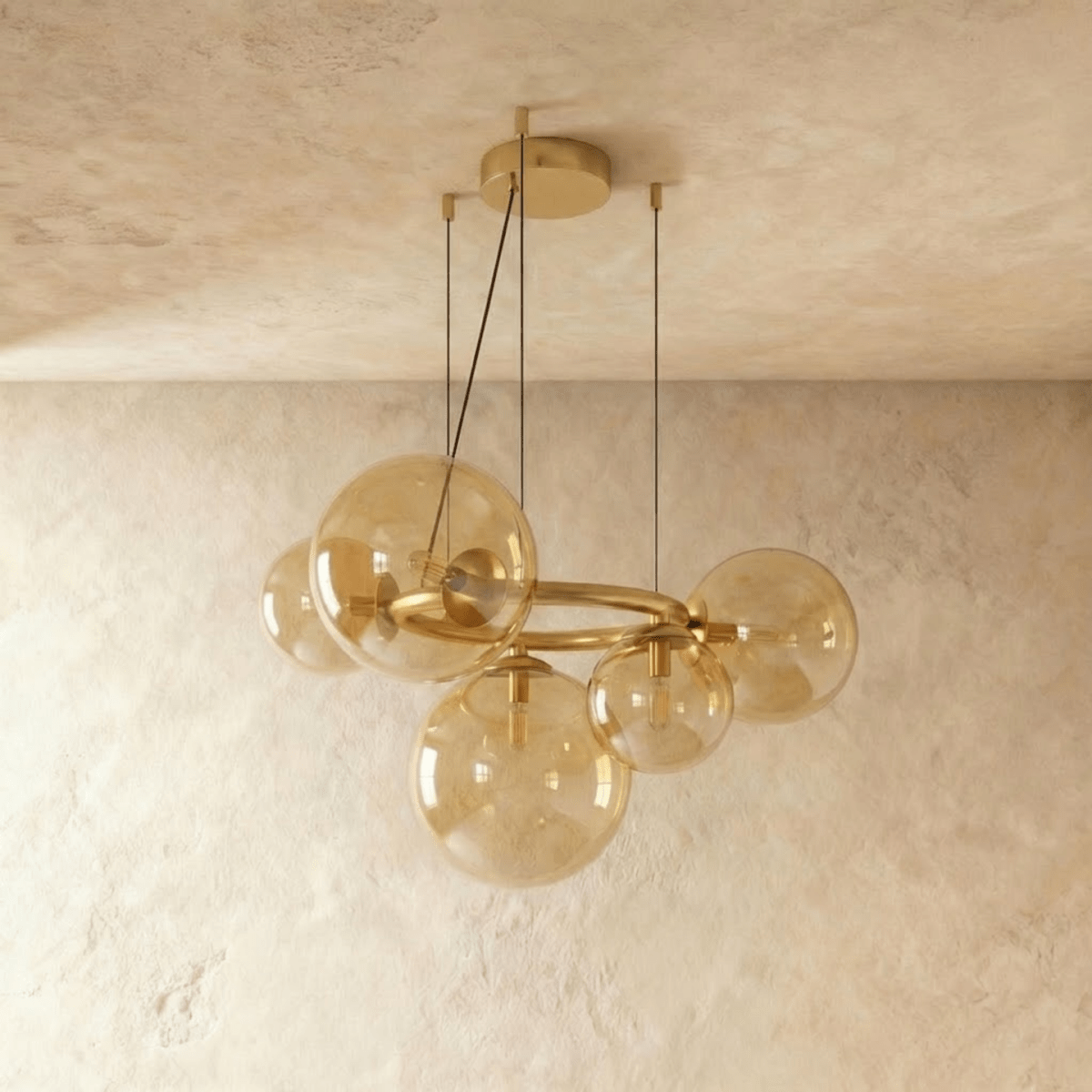 Clérachic globe cluster chandelier in Amber Glass, another angle of its warm-toned spheres on brass.