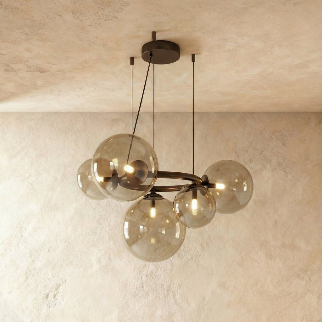 Clérachic globe cluster chandelier in Smoky Gray Glass, its tinted spheres grouped on a dark metal ring.