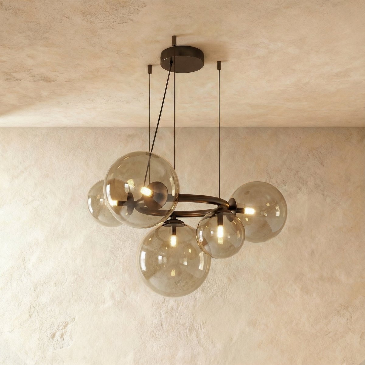 Clérachic globe cluster chandelier in Smoky Gray Glass, its tinted spheres grouped on a dark metal ring.
