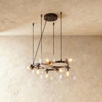 Clérachic globe cluster chandelier in Clear Glass, its clear spheres and warm bulbs clustered on a dark ring.