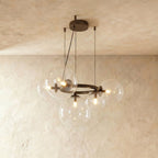 Clérachic globe cluster chandelier in Clear Glass, viewed from another angle with bulbs glowing inside each sphere.