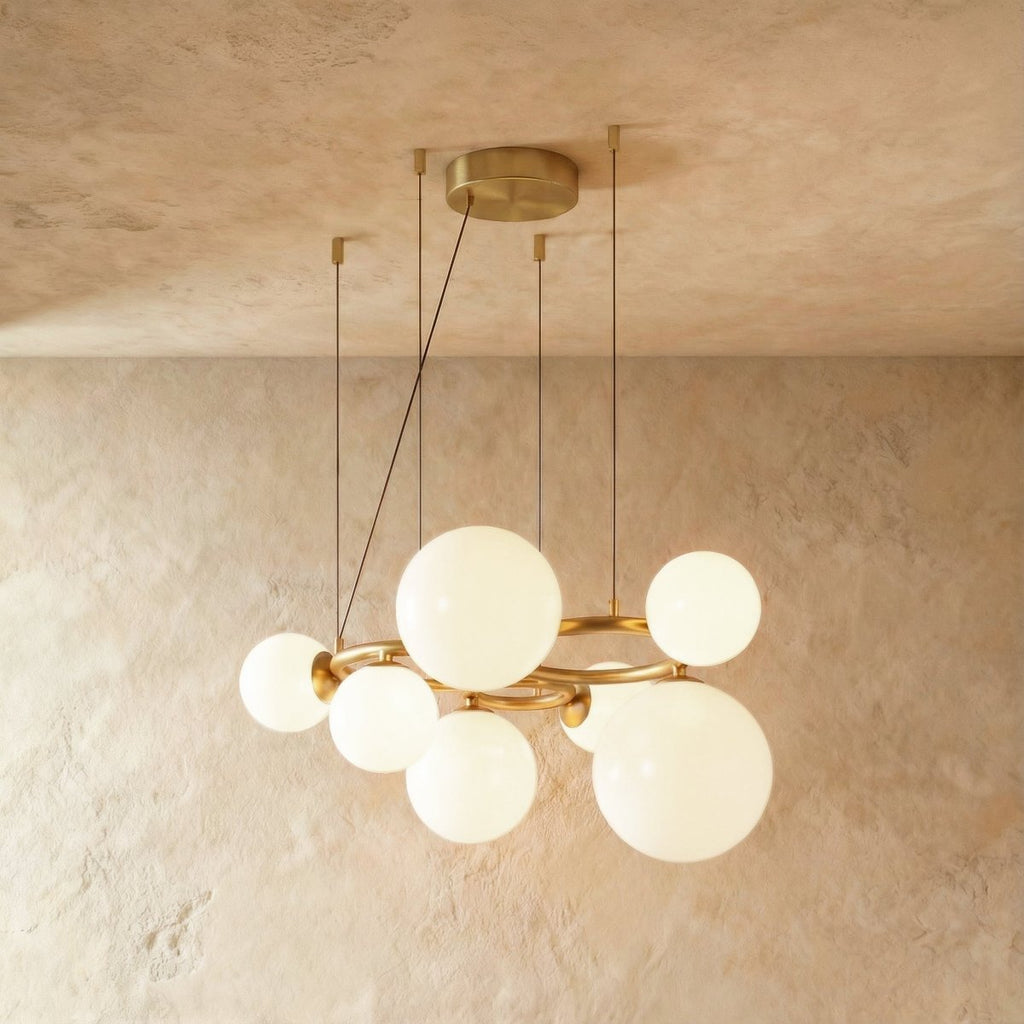 Clérachic globe cluster chandelier in Milk White Glass, opaque white spheres grouped on a brass ring frame.