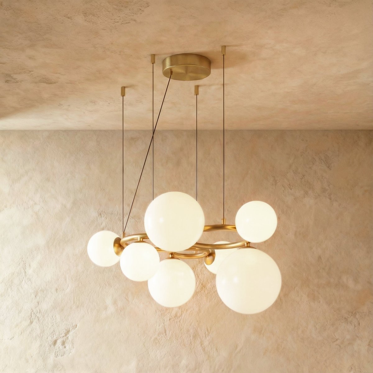 Clérachic globe cluster chandelier in Milk White Glass, opaque white spheres grouped on a brass ring frame.