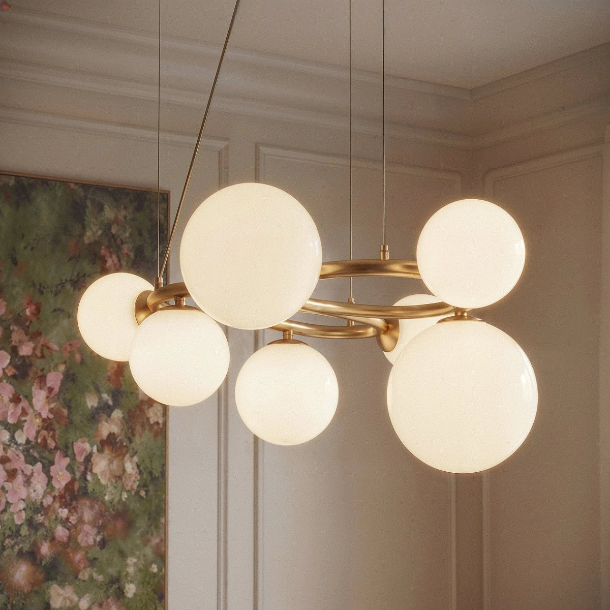 Clérachic globe cluster chandelier in Milk White Glass glows in a panelled living room beside a floral painting.