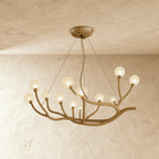 Clérachic branch chandelier, frosted glass globes glowing warm across a wider spread of bronze branches.