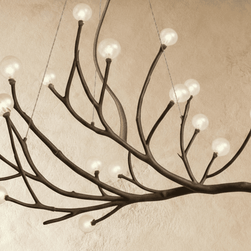 Clérachic branch chandelier detail, clear glass globes lit warm along the textured bronze branch arms.