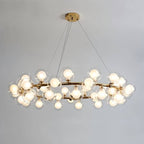 Clérachic large gold ring chandelier packed with clear glass globes and frosted bulbs, hung on cables from a round gold ceiling plate.