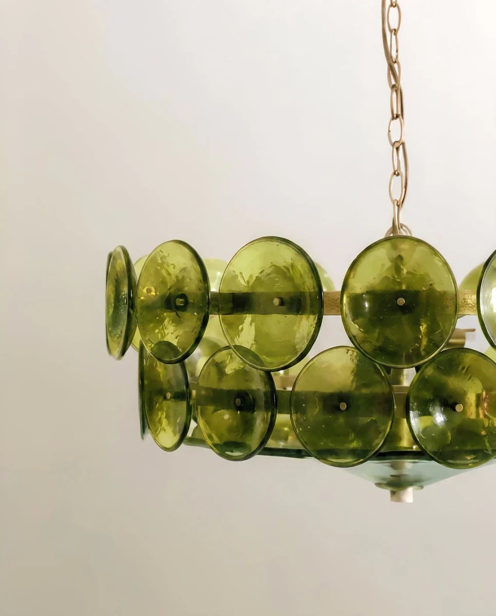 Clérachic chandelier seen from below, olive-green rippled glass discs fixed to brass bands with small pins and a glass base.
