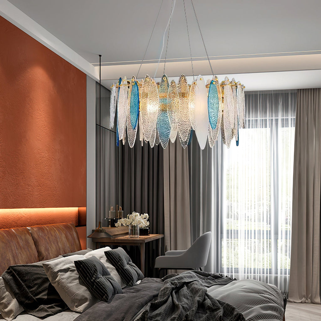 Clérachic leaf-glass chandelier hanging in a bedroom with a rust-orange wall and long grey curtains.