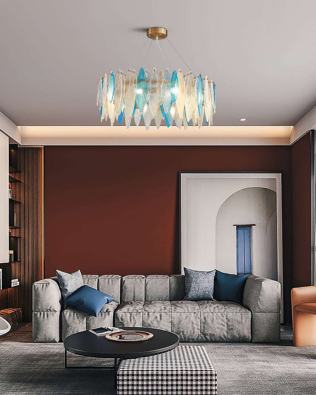 Small Clérachic chandelier with blue and clear glass leaves above a grey sofa and round coffee table.