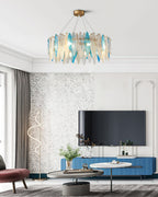 Clérachic leaf-glass chandelier centred in a white living room with a wall-mounted TV on a blue unit.