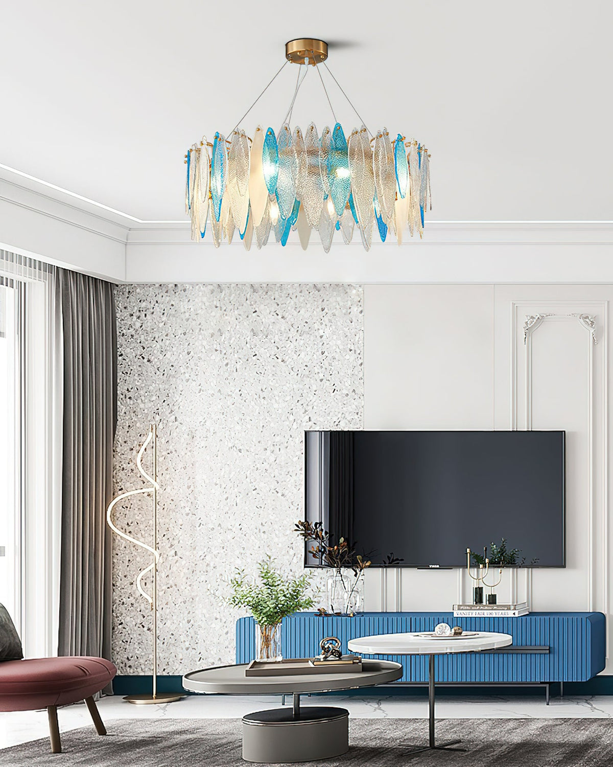 Clérachic leaf-glass chandelier centred in a white living room with a wall-mounted TV on a blue unit.