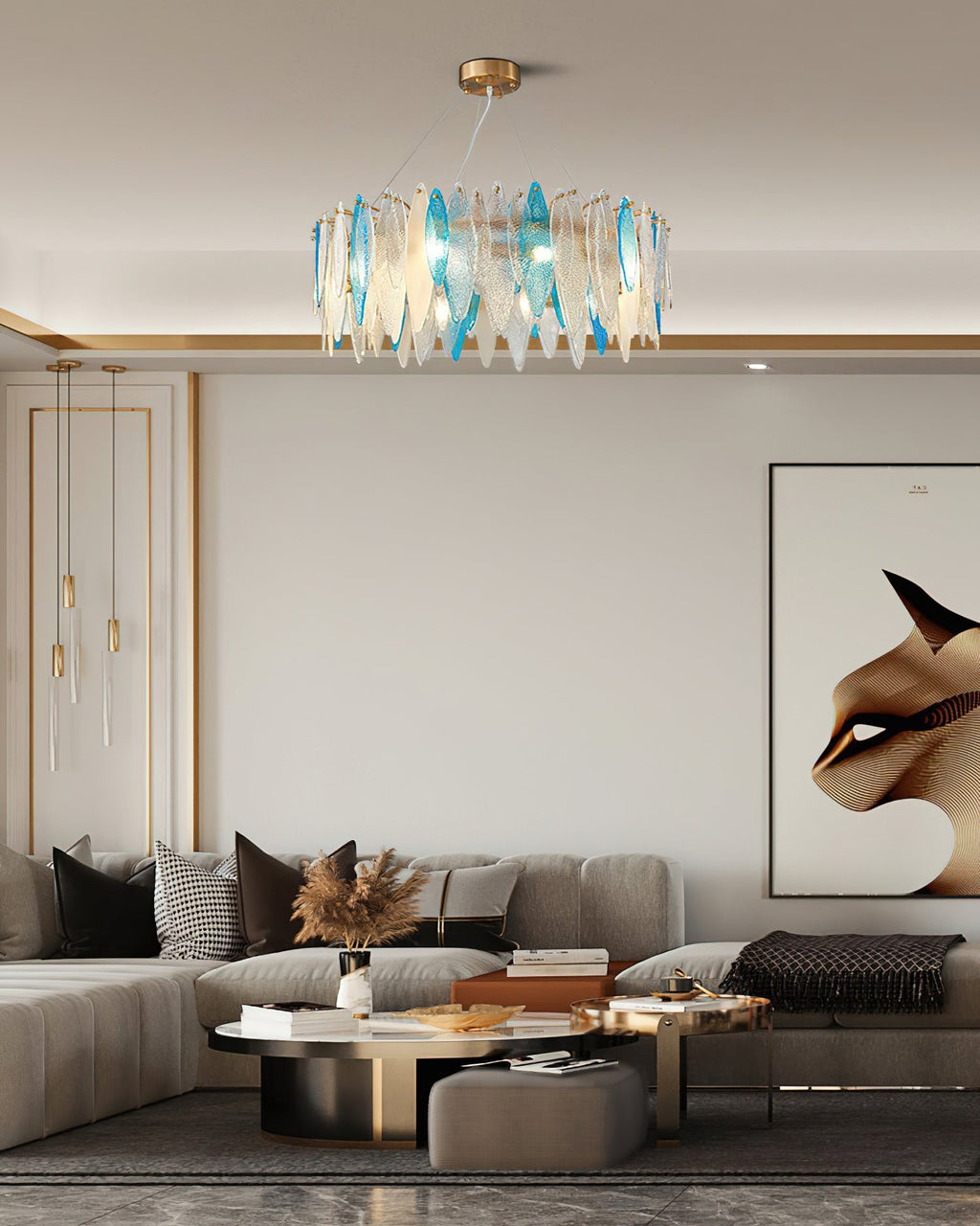 Clérachic chandelier with blue and clear glass leaves above a neutral living room with a low sofa.