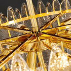 Close view of the gold frame, spokes and candle-style fittings inside this Clérachic glass chandelier.