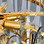 Close view of a candle-style LED filament bulb in a gold holder inside this Clérachic chandelier.