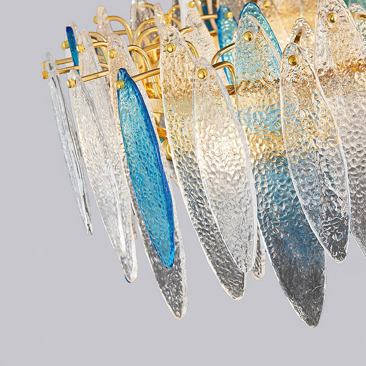 Underside view of the layered clear and blue glass leaves on this Clérachic chandelier, tinted smoke grey at the tips.