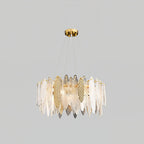 Clérachic chandelier in gold with clear textured glass leaves, hung on fine wires against light grey.