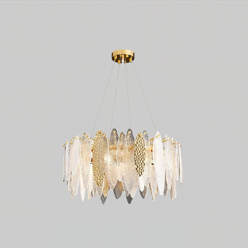 Clérachic chandelier in gold with clear textured glass leaves, hung on fine wires against light grey.