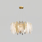 Larger Clérachic chandelier with clear glass leaves and a few gold hammered-look panels, on a grey backdrop.
