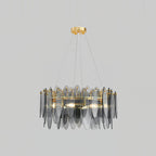 Clérachic chandelier with overlapping smoke grey glass leaves on a gold frame, lit against light grey.