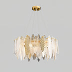 Wide Clérachic chandelier of clear glass leaves with gold hammered-look panels, lit on a grey backdrop.