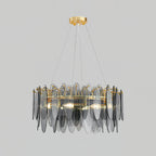 Wide Clérachic chandelier with layered smoke grey glass leaves around a gold ring, on light grey.