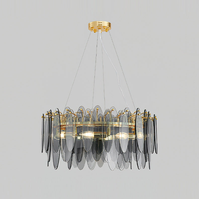 Wide Clérachic chandelier with layered smoke grey glass leaves around a gold ring, on light grey.