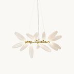 Front view of this Clérachic round chandelier on a plain white backdrop, frosted white glass leaves rising from a slim gold ring.