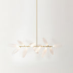 A linear Clérachic chandelier seen from a low angle, its frosted white glass leaves on a gold bar hanging from a long gold rod.