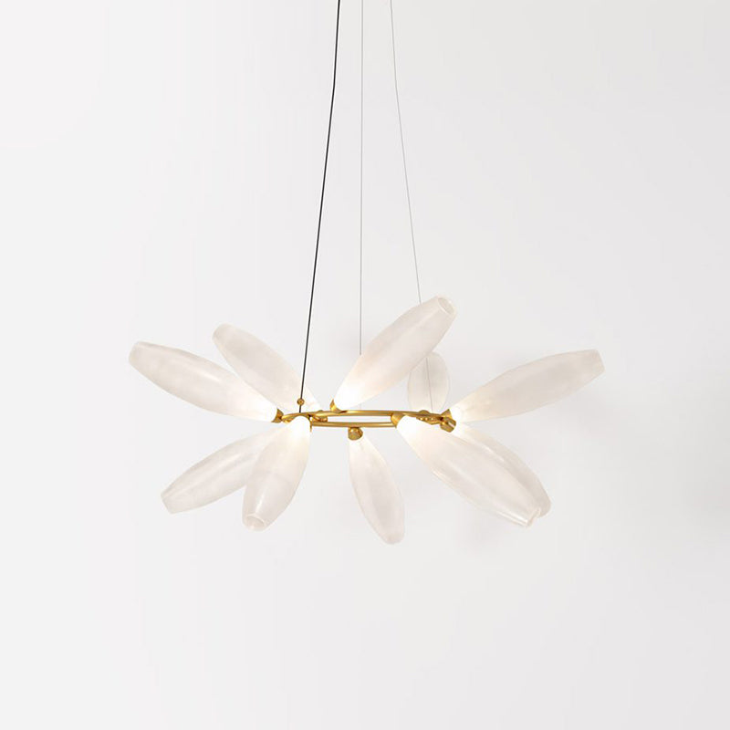 A round Clérachic chandelier in three-quarter view, with white glass leaves radiating from a gold ring on a pale backdrop.