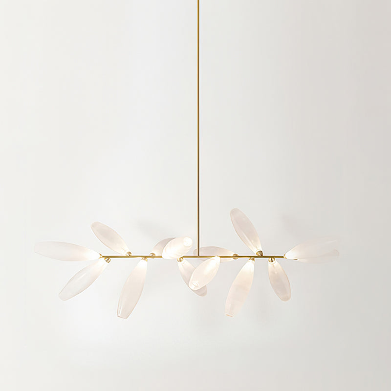 A long, linear Clérachic chandelier of frosted glass leaves on a gold bar, hung from a single gold rod against a pale backdrop.