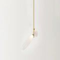 Close view of two frosted glass leaves on a gold stem, one angled down, from this Clérachic chandelier against a pale wall.