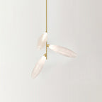 Three frosted glass leaves branching from one gold stem, a single arm of this Clérachic chandelier on a pale backdrop.