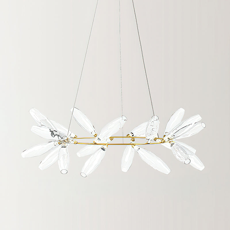 A round Clérachic chandelier in a clear glass finish, with transparent leaves on a gold ring and fine wires against a pale backdrop.