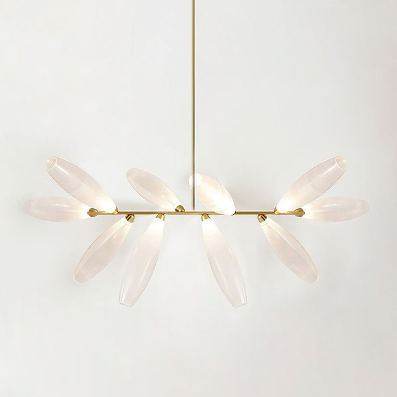 A linear Clérachic chandelier of lit frosted glass leaves on a gold bar, hung from a gold rod against a pale backdrop.