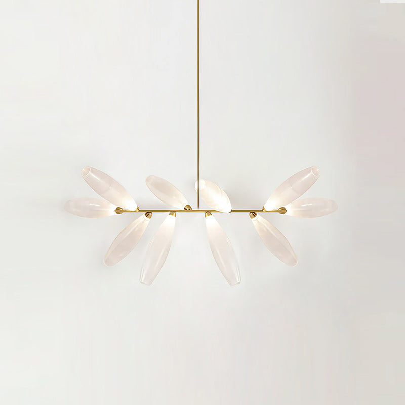 A smaller linear Clérachic chandelier of lit frosted glass leaves on a gold bar, hung from a gold rod against a pale backdrop.