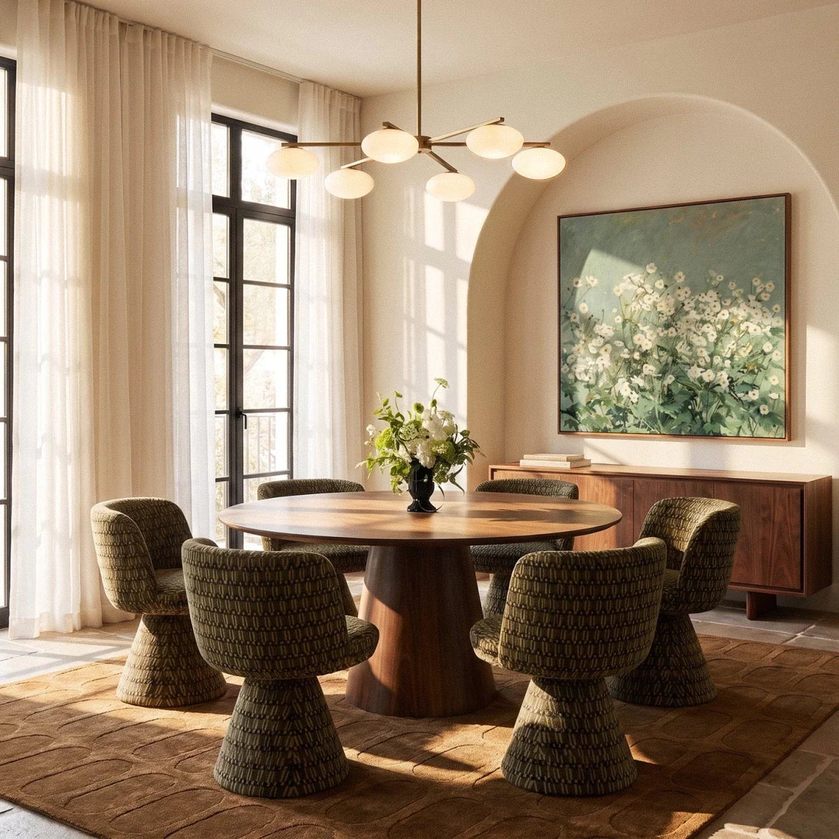 Clérachic six-head brass chandelier with opal glass shades above a round walnut dining table, with a painting behind.