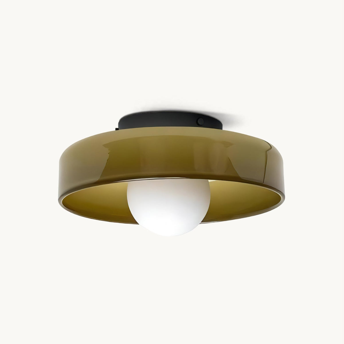 Flush ceiling light from Clérachic with an olive glass disc, a black mounting plate and a white globe bulb beneath, on white.