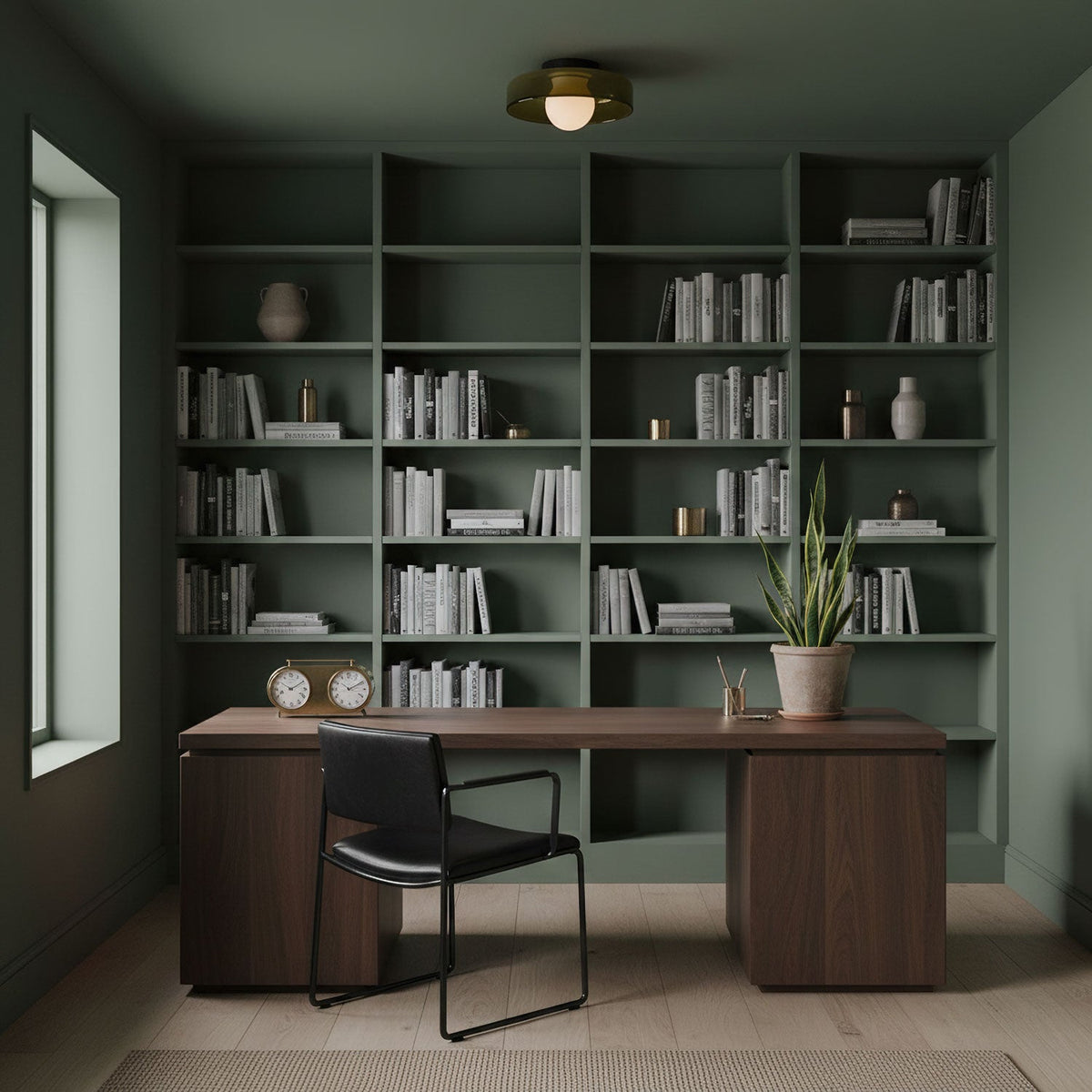 Above a walnut desk and sage green shelving, this Clérachic glass-disc ceiling light sits flush with the ceiling, its globe lit.