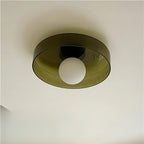Underside of an olive-brown Clérachic glass disc with a frosted white globe, against a cream ceiling.