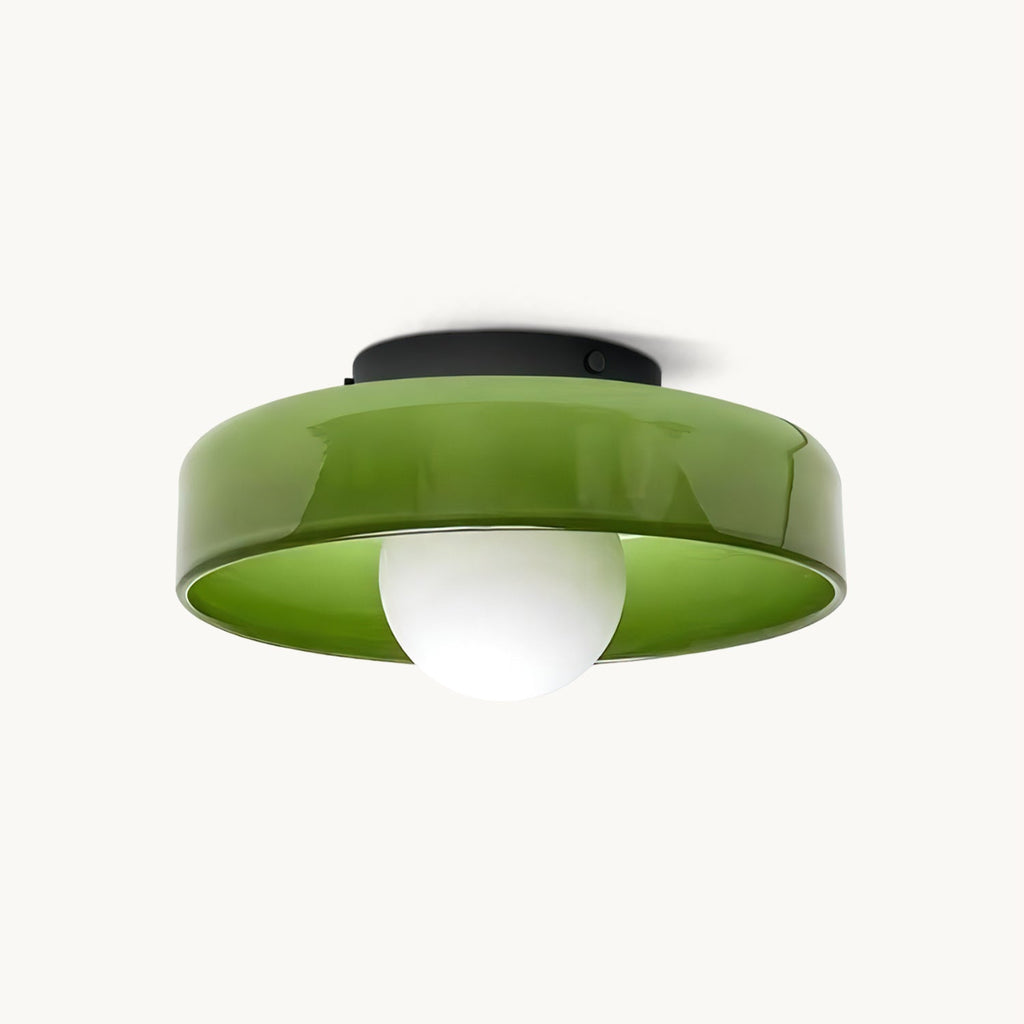 Green glass disc ceiling light from Clérachic with a black plate and a white globe bulb, shown on an off-white backdrop.