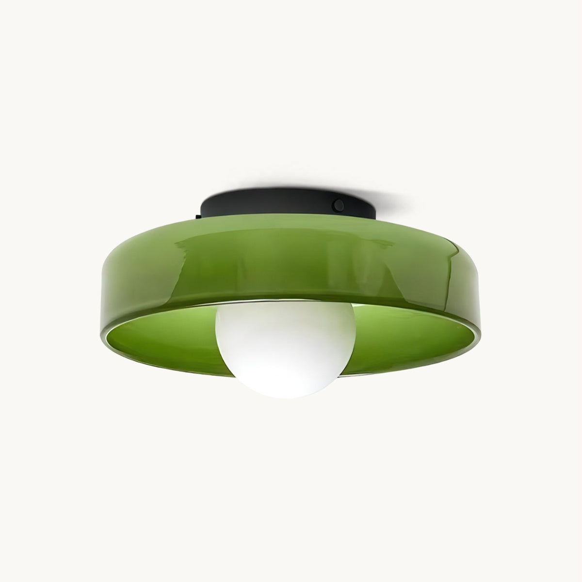 Green glass disc ceiling light from Clérachic with a black plate and a white globe bulb, shown on an off-white backdrop.