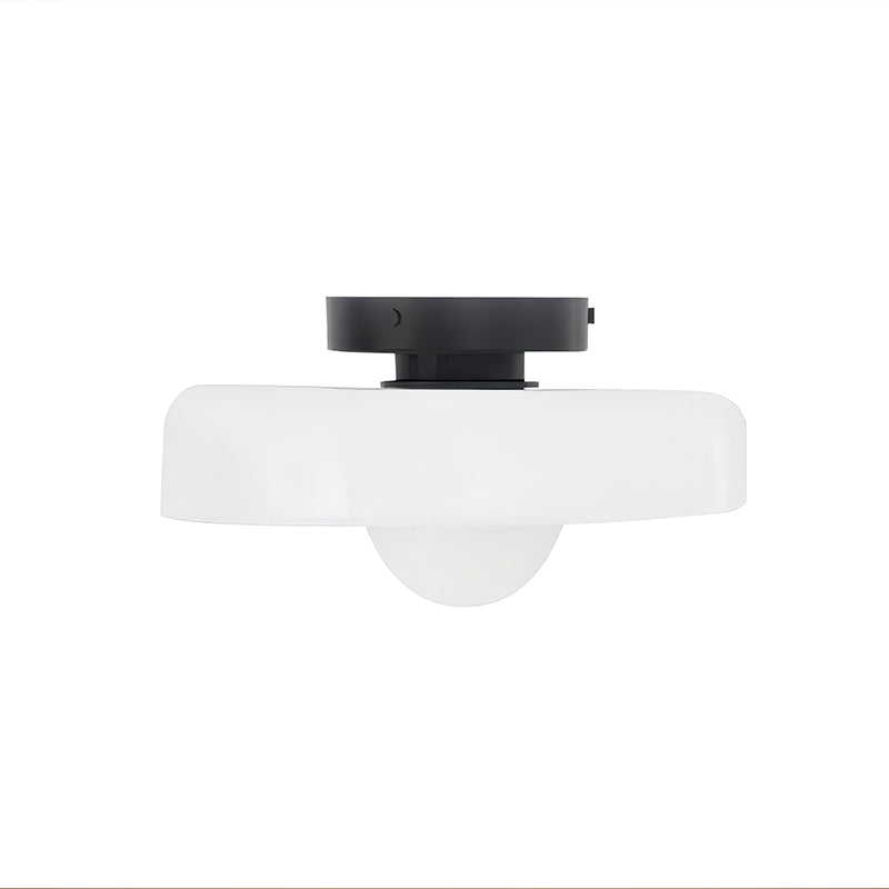 White glass-disc ceiling light from Clérachic with a black plate and a white globe underneath, on a plain white backdrop.