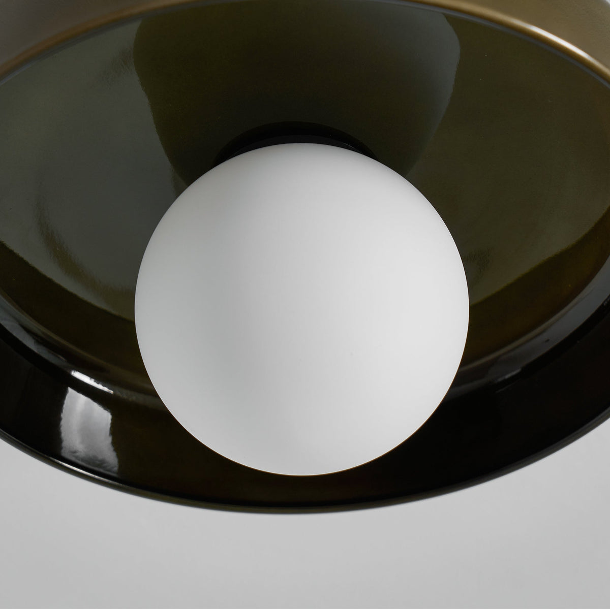 Close view of the frosted white globe inside the olive glass disc of this Clérachic ceiling light, unlit.